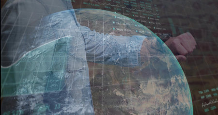 Glancing businessman in blue shirt, tie checking wristwatch in office, holographic globe, charts. Technology, finance, innovation, analytics, data visualization, corporate, professionalの写真素材