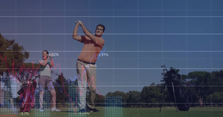 Man in orange polo swinging golf club on golf tee, with golf bag. Athletic, leisure, outdoor, wellness, professional, activity, harmonyの写真素材