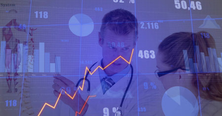 Doctor wearing labcoat gesturing toward line graph in tech lab with stethoscope and data screens. Medical, technology, research, diagnostics, innovation, data visualization, collaborationの写真素材