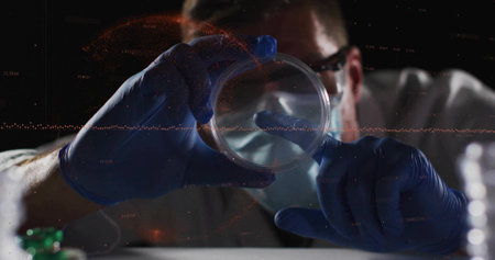 Examining scientist wearing lab coat mask glasses gloves holding petri dish at lab bench with vials. Scientist, innovation, precision, microscopy, technology, research, diagnosticsの写真素材
