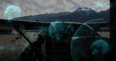 Technician in coveralls crouching at twin engine plane in hangar, with tools and holographic grids. Aviation, technology, maintenance, futuristic, infrastructure, engineering, industryの写真素材