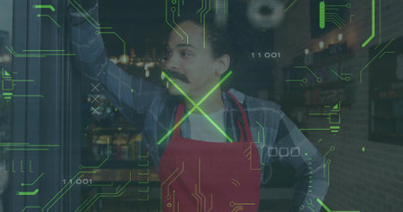 Leaning cafe worker wearing red apron and plaid shirt looking outward in cafe, with digital overlay. CafÃ©, hospitality, digital interface, warm lighting, cozy environment, modern technology, storefrontの写真素材