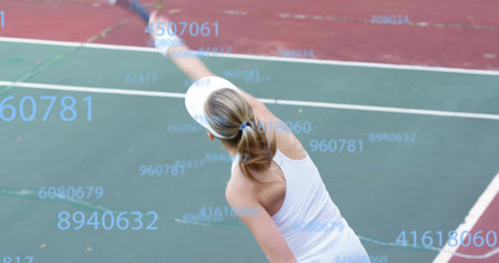 Tennis player in visor serving ball with racket on hard court lines, with numeric overlay. Athlete, sport, athleticism, competition, outdoor, vibrant, performanceの写真素材
