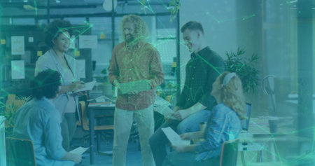 Group of colleagues reviewing documents and planning in open-plan office, with sticky notes. Collaboration, teamwork, brainstorming, communication, modern, professional, workspaceの写真素材