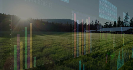 Overlaying bar charts and data panels over crop field, barn, evergreen trees, hills under low sun. Agribusiness, landscape, analytics, visualization, digital, rural, ecologicalの写真素材