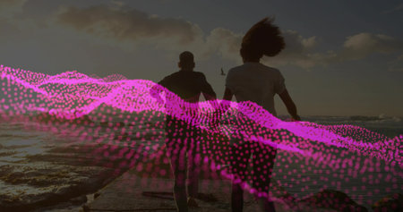 Running couple wearing t-shirts and shorts approaching shoreline at sunset, with pink wave overlay. Silhouette, athletic, adventure, harmony, empowerment, vibrant, dynamicの写真素材