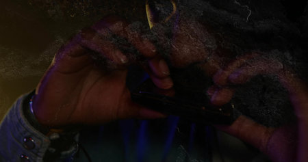 Denim-shirted musician playing harmonica on stage under purple amber lighting, grainy overlay. Musician, stage, performance, artistic, retro, vintage, instrumentの写真素材