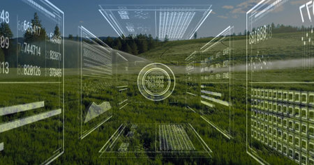 Floating circular digital interface hovering over rural hillside meadow, with numeric data panels. Futuristic, digital, hologram, data visualization, immersive, green landscape, technologyの写真素材