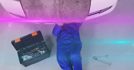 Mid-adult woman tapping tablet presenting stock data overlays while colleague watching in financeの写真素材