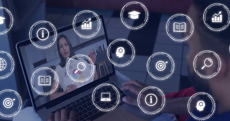 Man interacting with laptop screen at desk in home office with floating analytics icons overlay....