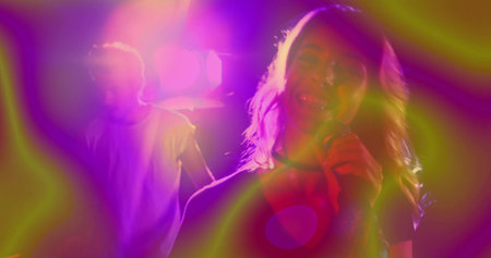 Performing female singer holding microphone on stage in music venue, with lighting rig, lens flares. Concert, performance, stage, nightlife, entertainment, vibrant, atmosphereの写真素材