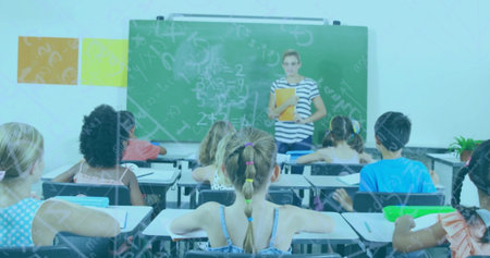 Teacher explaining math on chalkboard to children, wearing striped top and holding folder in school. Education, classroom, learning, instruction, school, teaching, studentsの写真素材