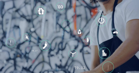 Apron-clad mechanic adjusting icons in bike repair shop, with frames wheels, copy space. Engineering, maintenance, technology, sustainability, innovation, workshop, manualの写真素材