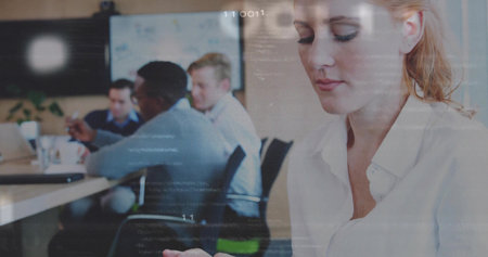 Using tablet woman in buttonâdown shirt reviewing notes in meeting room, with laptops, copy space. Collaboration, teamwork, professional, corporate, communication, modern, technologyの写真素材