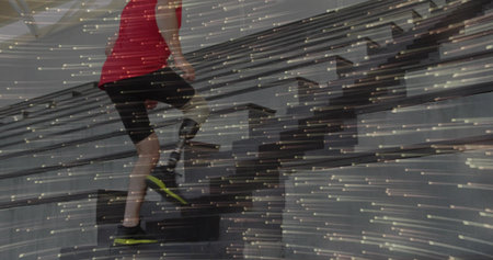 Climbing man wearing red T-shirt on rehab staircase with prosthetic leg, neon shoes, copy space....