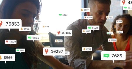 Analyzing metrics on smartphone, tablet by team in business attire in office, with digital overlays. Collaboration, teamwork, digital, data, technology, professional, modernの写真素材