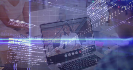 Watching colleague wearing white blouse sharing code on laptop at office desk, with binary overlay. Technology, innovation, collaboration, digital, workspace, software, communicationの写真素材