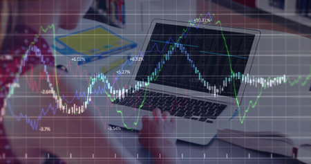 Female teen student analyzing stock market graphs in home study room, laptop, notebook, copy space....