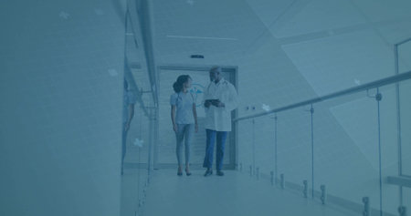 Walking nurse and doctor discussing patient care in hospital corridor, with stethoscopes and tablet. Medical staff, healthcare, clinical, professionalism, teamwork, modern, interiorの写真素材