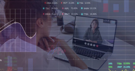 Asian woman reviewing charts in office on laptop call with colleague in business blouse. Professional, digital, modern, analytical, collaborative, sleek, data-drivenの写真素材
