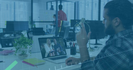 Talking bearded man in plaid shirt collaborating with colleagues on laptop in office, copy space. Collaboration, teamwork, modernoffice, digitalcommunication, technology, productivity, workspaceの写真素材