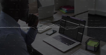 Analyzing man in business shirt studying laptop at office desk, with neon sticky notes, copy space....