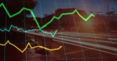 Displaying tri color line graph curves over gridlines, blurred rural railway at dusk with sun flare. Analytics, visualization, data, innovation, technology, finance, industryの写真素材