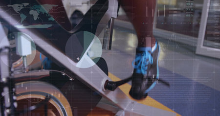 Pedaling gym-goer engaging bike pedal against flywheel in fitness center. Exercise, training, motivation, sport, metallic, motion, urbanの写真素材