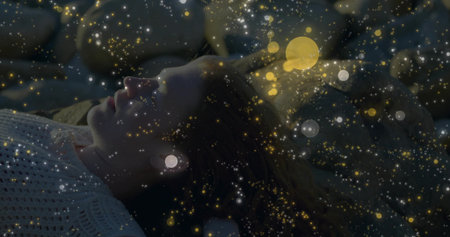 Lying woman wearing knitted sweater fanning hair on pillows in cozy bedroom, with glowing particles....