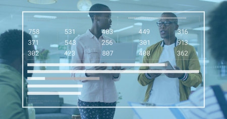 Presenters in casual attire analyzing data charts in office lounge, with laptop, tablet, documents....