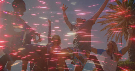 Friends in summerwear jumping on dock by ocean horizon, with palm tree and light streaks. Celebration, adventure, leisure, vibrant, outdoor, camaraderie, freedomの写真素材