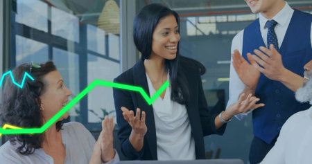 Businesswoman in blazer presenting in office meeting room, with laptop and neon-green blue graphs. Collaboration, leadership, teamwork, professional, analytics, innovation, corporateの写真素材