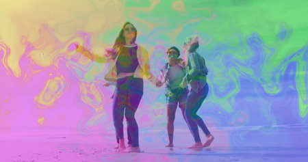 Running friends holding hands on sunny sandy shoreline, wearing jeans, light jackets and sunglasses. Breeze, camaraderie, outdoor, leisure, casual, vibrant, energeticの写真素材