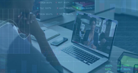 Conducting virtual meeting with colleague on laptop screen in office, smartphone and stock charts. Technology, collaboration, digital, finance, productivity, business, remoteの写真素材