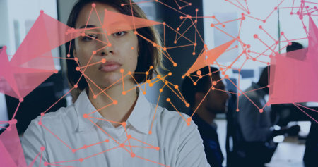 Businesswoman in white shirt presenting to colleagues in office, with monitors and network overlay. Professional, collaboration, innovation, technology, modernity, communication, connectivityの写真素材