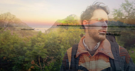Standing traveler wearing padded jacket and backpack at lakeside sunset, with boats, copy space. Scenic, adventure, exploration, tranquility, nature, landscape, horizonの写真素材