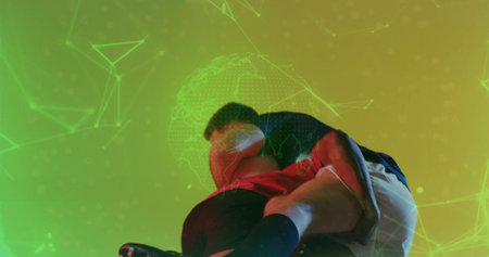 Athletes executing wrestling hold on opponent in VR arena with jerseys shorts socks and cleats. Action, competition, sports, fitness, digital, futuristic, strengthの写真素材