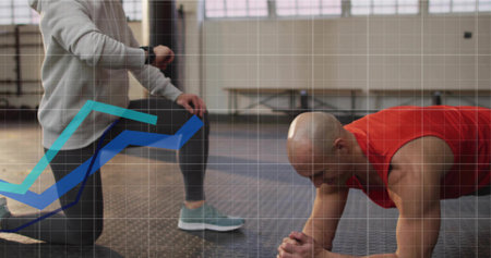 Male client holding plank in gym on mat, trainer checking smartwatch, copy space. Fitness, training,...
