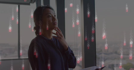 Standing business woman holding tablet and looking out office windows with binary code, copy space. Corporate, modern, sleek, innovative, technology, consultancy, professionalの写真素材