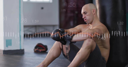 Adjusting male boxer tightening gloves in boxing gym, with heavy bag and data overlay, copy space. Athleticism, determination, performance, strength, discipline, combat, trainingの写真素材
