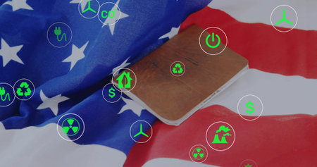 Displaying brown leather notepad on folded US flag desk featuring digital energy and finance icons. Patriotism, sustainability, eco-friendly, innovation, technology, finance, flat layの写真素材