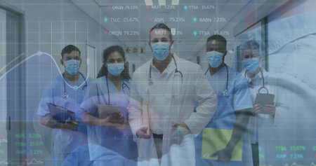 Standing medical team in scrubs analyzing data in hospital corridor with stethoscopes, data overlay. Healthcare, collaboration, digitalhealth, professional, teamwork, clinical, modernの写真素材