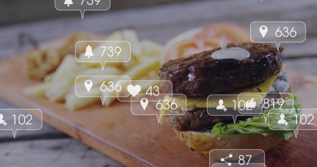 Showing double cheeseburger with lettuce sauce on board with fries plus social overlays, copy space. Fast food, burger, social media, digital interface, casual dining, comfort food, visual engagementの写真素材