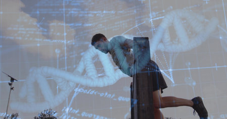 Leaning on wooden beam, man doing dip exercise outdoors, with tripod stand and DNA graphic overlay....