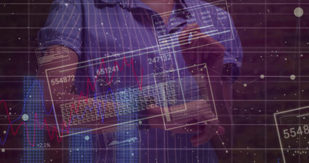 Man wearing blue shirt holding keyboard, swiping data panels at brick wall with holographic charts. Technology, innovation, futurism, digital, data visualization, workstation, modernの写真素材