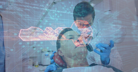 Examining dentist leaning over patient in dental chair at clinic, with handheld instrument and lamp. Dental hygiene, health, clinical, professional, sterile, modern, evaluationの写真素材