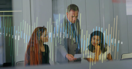 Leaning man in gray suit presenting paper to colleagues at conference room, with bar chart overlay. Corporate, teamwork, presentation, analytics, professional, collaboration, modernの写真素材