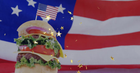 Displaying cheeseburger with cheese on US flag backdrop, flag toothpick and confetti, copy space. Fast food, americana, celebration, patriotism, festive, gourmet, cartoon styleの写真素材