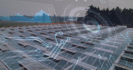 Extending rows solar panels on rack mounts over rural grassy ground, displaying data overlays....