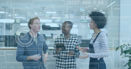 Colleagues discussing data graphics on smartphone and tablet in office, holding coffee mugs. Teamwork, innovation, technology, collaboration, modernity, analytics, digitalの写真素材